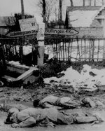 Dead American soldiers laying face down at a crossroad in Belgium, Dec 1944