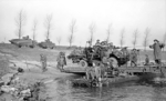 A truck-mounted 40-mm Bofors anti-aircraft gun of UK 15th (Scottish) Division crossing the Rhine River near Xanten, North Rhine-Westphalia, Germany, 24 Mar 1945