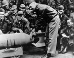 Doolittle wiring a Japanese medal to a bomb, Apr 1942, 2 of 2