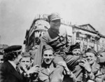 Chinese Army junior officer celebrating with British soldiers, London, England, United Kingdom, 7 May 1945