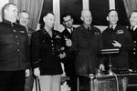 Ivan Susloparov, Frederick Morgan, Walter Smith, Dwight Eisenhower, Arthur Tedder, and Harold Burrough after signing of German surrender documents, Rheims, France, 7 May 1945; note Eisenhower holding pens used, and Eisenhower