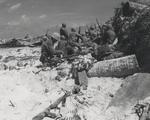 US Marines taking cover behind a barricade on 