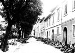 Japanese-American troops of 100th Infantry Battalion of US 442nd Regimental Combat Team resting on the side of a street in Livorno, Castellina Sector, Italy, 19 Jul 1944