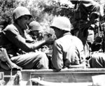 American soldier lighting cigarette of a Japanese-American soldier, both of the US Army, Castellina Sector, near Livorno, Italy, 25 Jul 1944