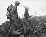 A US Marine threw a grenade at enemy sheltered in a northern Iwo Jima cave, Japan, Feb-Mar 1945