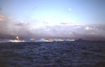 Battleship Tennessee and a Fletcher-class destroyer provide gunfire support while LVTs raced for the beaches of Iwo Jima, morning of 19 Feb 1945