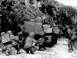 US Marines advancing under the cover of a M4 Sherman medium tank, northern Saipan, Mariana Islands, 8 Jul 1944