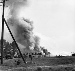 A convoy of British trucks under German artillery and mortar fire on the road between Son and Eindhoven, the Netherlands, 20 Sep 1944