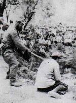 Japanese soldier preparing to execute a Chinese man, Nanjing, China, Dec 1937-Jan 1938