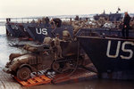 A US Army half-track antiaircraft machine gun vehicle backed into the well deck of a US Navy LCT in preparation for the Normandy invasion, late May or early Jun 1944. Photo 1 of 2