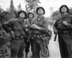 Four US Army soldiers watching Allied bombardment, Saint-Lô, France, Jun 1944