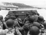 American troops watched activity ashore on Omaha Beach as their LCVP landing craft approached the shore, Normandy, France, 6 Jun 1944, photo 1 of 2