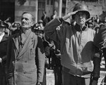 An US Army colonel and a French civilian in Cherbourg during the playing of the American national anthem, 28 Jun 1944