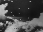 Japanese paratroopers descending on Pangkalan Benteng airfield or Pladju refineries in southern Sumatra, Dutch East Indies, 13 Feb 1942, photo 1 of 2