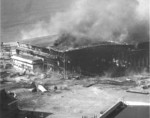 Seaplane hanger ablaze after being bombed by Japanese aircraft, Ford Island, Pearl Harbor, US Territory of Hawaii, 7 Dec 1941, photo 1 of 2