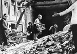 Boy with caged canary in ruins, Warsaw, Poland, Sep 1939