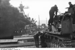 German Panzer IV tank and crew at Toulon harbor, France, 27 Nov 1942; note French cruiser Colbert burning in background