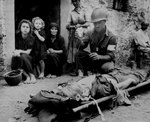 US Army Private First Class Harvey White administering plasma to wounded Private Roy Humphrey, Sicily, Italy, 9 Aug 1943