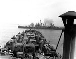 USS Boise firing on armor forces near Gela, Sicily, Italy as LST-325, full of US Army trucks, approached the landing beaches, 11 Jul 1943