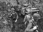 Men of the US First Marines Division at Cape Gloucester, New Britain, Bismarck Archipelago, circa late Dec 1943; note jeep being used to haul supplies