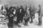 SS troops rounding up suspected Jewish resistance fighters, near intersection of Nowolipie Street and Smocza Street, Warsaw, Poland, Apr-May 1943