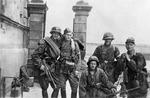 Polish resistance fighters Wlodzimierz Denkowski (with Thompson submachine gun), Lech Zubrzycki, Jan Baginski, and Zygmunt Siennicki (with MP35 submachine gun) of the Kedyw (Directorate of Sabotage) on Stawki Street in Wola district, Warsaw, Poland, circa 11 Aug 1944