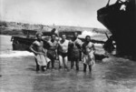 Chaplain John Craven of US 14th Marine Regiment with four men of US Army 476th Amphibious Truck Company whom he had just baptized, Iwo Jima, Japan, 1945