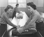 Female US Marines Private Marion Chadwick, Private Jessie Young, and Private Marjorie Barrett rigging parachutes, Camp Lejeune, North Carolina, United States, circa 1943