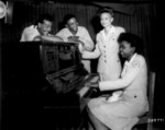 African-American US Army soldiers and American Red Cross workers in Assam, India, 23 Aug 1944; L to R: Cpl Robert Barttow, Pvt James Montgomery, Jeannette C. Dorsey, and Willie Lee Johnson