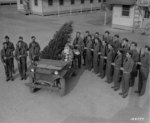 US Army soldier dressed as Santa Claus during the Christmas holiday season at Camp Lee, Virginia, United States, Dec 1941, photo 2 of 2; note Springfield M1903 rifles