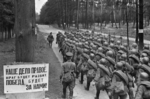 Soviet troops marching near Moscow, Russia, 23 Jun 1941; text of poster at left: 