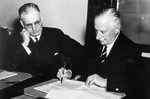 Governer General of Australia Lord Gowrie signing the declaration of war against Japan with Prime Minister John Curtin looking on, at 1115 hours, 8 Dec 1941 (2015 hours, 9 Dec 1941 local time)