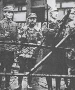 Heinrich Himmler (third from left, holding flag) outside the office of the Military District for Bayern (Bavaria) during the Beer Hall Putsch, München (Munich), Germany, 9 Nov 1923