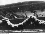 Chancellor Hitler saluting the athletes from balcony of the Olympic House during opening ceremony of the IV Olympic Winter Games, Garmisch-Partenkirchen, Bavaria, Germany, 6 Feb 1936, photo 1 of 4