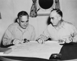 Rear Admiral Daniel Barbey (left) and Vice Adimral Thomas Kinkaid (right) studying a map of New Guinea aboard Barbey