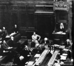 MacArthur seated next to the Speaker of the House of Representatives Mr. Nairn, Provisional Parliament House, Canberra, Australia, 1942; note Curtin seated at table