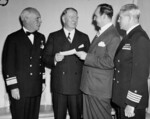 US Secretary of the Navy Frank Knox receiving a USD $63,000,000 check from Chairman of the City of Atlanta John Connor during a War Bond selling campaign, nominally for the replacement for the sunken cruiser USS Atlanta, Mar 1943; note Rear Admiral George Murray at left of photograph and Captain Samuel Jenkins at right of photograph