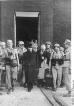 Former Italian Prime Minister Benito Mussolini and Inspector General Giuseppe Gueli being escorted out of Hotel Campo Imperatore, Gran Sasso, Italy, 12 Sep 1943, photo 1 of 2