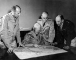 Major General Richard Sutherland, Admiral Chester Nimitz, Vice Admiral Robert Ghormley, and Major General Millard Harmon meeting aboard USS Argonne at Nouméa, New Caledonia, 28 Sep 1942