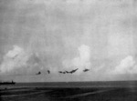 FM-2 fighter being launched from USS Coral Sea during combat off Saipan, Mariana Islands, 18 Jun 1944; note USS Corregidor in background