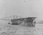 HMS Argus in dazzle camouflage in the Firth of Forth, Scotland, United Kingdom, circa late 1918; note Forth Bridge in background