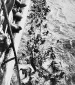 Survivors of battleship Bismarck being pulled aboard HMS Dorsetshire, 27 May 1941