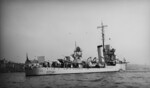 USS Ellet anchored in Hudson River during the Presidential Naval Review, New York, United States, 27 Apr 1939; note motion picture screen rigged over her stern depth charge racks and New Jersey in background