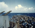 USS Essex on her shakedown cruise, 20 Mar 1943, with F6F aircraft in foreground and SBD in the back