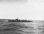 Japanese destroyer Hatsuzakura off Tokyo Bay with a whaleboat from USS Nicholas alongside to transfer Japanese translators and harbor pilots to Nicholas, 27 Aug 1945. Photo 1 of 2.