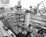 Indianapolis at Mare Island Navy Yard, California, view of port side of forward half, with light cruiser Raleigh in background, 19 Apr 1942