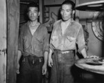 Two survivors of the sunken Jintsu, dressed in US Navy uniforms, aboard USS Nicholas (DD-449), 13 Jul 1943