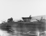 Incomplete Japanese submarine Ha-230 at Sasebo, Japan, 19 Oct 1945; note carrier Junyo (center), carrier Ibuki (center background, beyond Junyo), incomplete Unryu-class carrier Kasagi (right background), and a number of escort ships (left background)