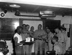 Lieutenant Commander Edward C. Outlaw and pilots of his VF-32 squadron celebrating after completing a mission over Truk, Caroline Islands, 29 Apr 1944