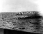 A whaleboat and a motor launch evacuated Lexington, 8 May 1942; TBD, SBD and F4F aircraft could be seen on the flight deck